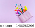 Colorful school supplies spilling from pink zipper pouch 140898206