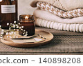 Cozy still life with candle, flowers, and books on dark table 140898208