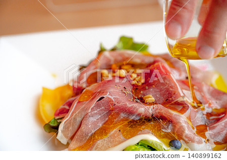 Prosciutto salad with olive oil Prosciutto salad with olive oil 140899162
