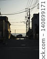 The silhouette of the sea stretches out beyond the twilight alley. 140899171