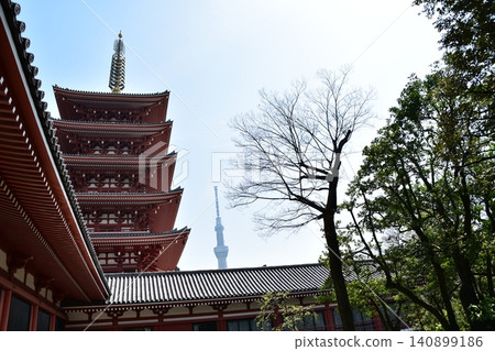 Asakusa, Tokyo, Japan: The five-story pagoda of Senso-ji Temple and the Tokyo Skytree visible from the temple grounds, against a beautiful blue sky, spring flowers, and fresh greenery. Asakusa, Tokyo, Japan: The five-story pagoda of Senso-ji Temple and the Tokyo Skytree visible from the temple grounds, against a beautiful blue sky, spring flowers, and fresh greenery. 140899186