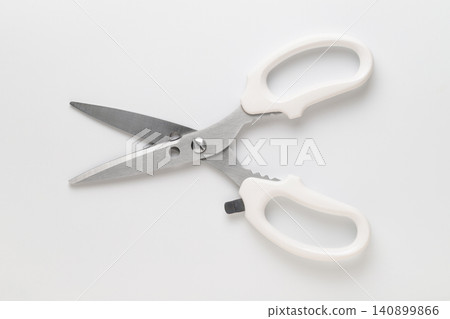 Kitchen scissors with a bottle opener placed against a white background. Kitchen scissors with a bottle opener placed against a white background. 140899866
