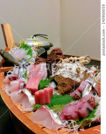 A boat-shaped platter of sashimi served at a traditional Japanese inn (Izu) A boat-shaped platter of sashimi served at a traditional Japanese inn (Izu) 140900059