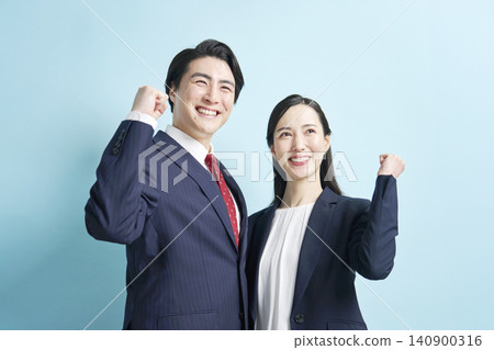 Male and female business people doing guts pose Male and female business people doing guts pose 140900316