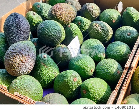 Lots of avocados in a cardboard box Lots of avocados in a cardboard box 140901013