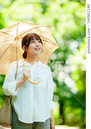 拿著遮陽傘的婦女在公園 140901140