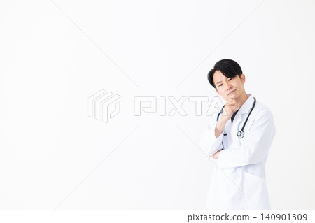 一位身穿白大褂的中年男醫生心事重重。 一位身穿白大褂的中年男醫生心事重重。 140901309