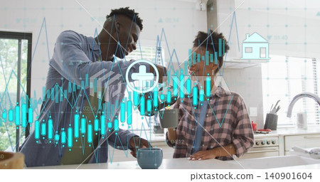 Fist-bumping couple wearing plaid blue shirts holding ceramic mugs in kitchen with charts overlay Fist-bumping couple wearing plaid blue shirts holding ceramic mugs in kitchen with charts overlay 140901604