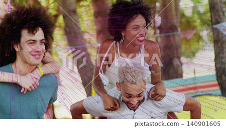 Playing four adults doing piggyback at park, woman in white top, man in teal-shirt, striped blanket Playing four adults doing piggyback at park, woman in white top, man in teal-shirt, striped blanket 140901605