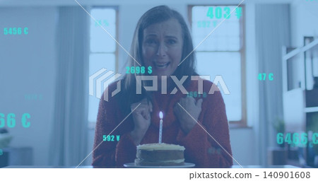 Sitting woman wearing red sweater clutching chest at dining table, with lit cake and teal overlays Sitting woman wearing red sweater clutching chest at dining table, with lit cake and teal overlays 140901608