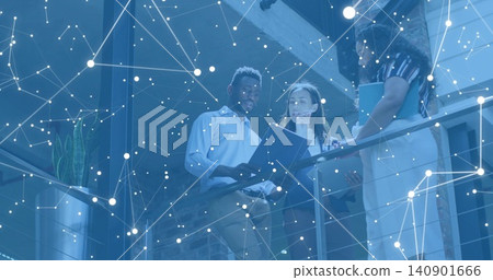 Reviewing documents, team wearing business checking tablet by mezzanine railing, digital overlay Reviewing documents, team wearing business checking tablet by mezzanine railing, digital overlay 140901666