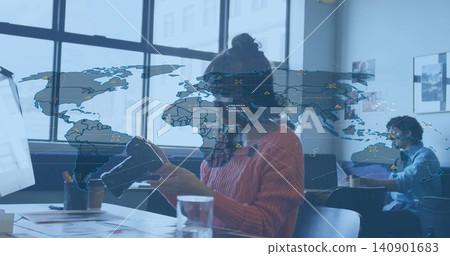 Holding and inspecting VR headset, Asian woman wearing rust sweater and glasses at coworking table Holding and inspecting VR headset, Asian woman wearing rust sweater and glasses at coworking table 140901683
