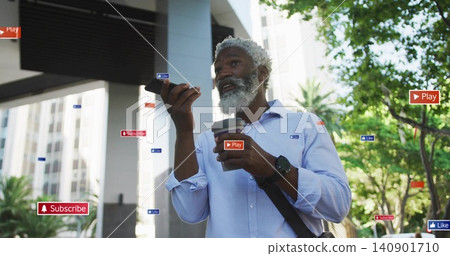 Speaking into phone, blue-shirt man holding coffee beneath overhang on street, showing AR badges Speaking into phone, blue-shirt man holding coffee beneath overhang on street, showing AR badges 140901710