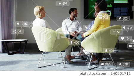 Four colleagues sitting in meeting room with one in yellow blazer, display and social icons Four colleagues sitting in meeting room with one in yellow blazer, display and social icons 140901711