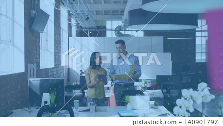 Talking blue-shirted man and yellow-blouse woman reviewing papers in loft office with yellow folder Talking blue-shirted man and yellow-blouse woman reviewing papers in loft office with yellow folder 140901797