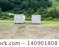 Two containers placed outdoors 140901808