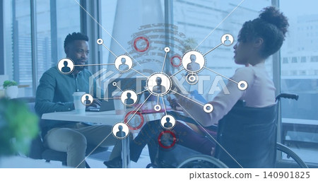 Discussing team reviewing data in office at round table, with laptops, wheelchair, network overlay Discussing team reviewing data in office at round table, with laptops, wheelchair, network overlay 140901825