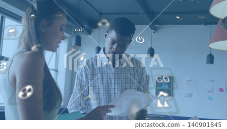 Reviewing man in checked shirt holding document, colleague pointing, in meeting area with AR icons Reviewing man in checked shirt holding document, colleague pointing, in meeting area with AR icons 140901845