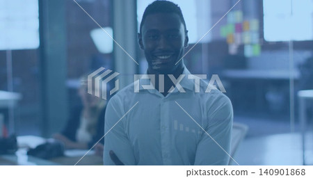 Standing man wearing white shirt, crossing arms, smiling in office with sticky notes on glass Standing man wearing white shirt, crossing arms, smiling in office with sticky notes on glass 140901868