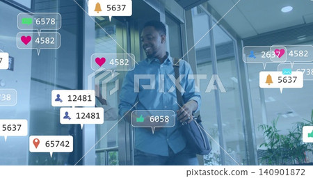 Exiting man wearing blue shirt with shoulder bag passing through glass office lobby, with AR badges Exiting man wearing blue shirt with shoulder bag passing through glass office lobby, with AR badges 140901872