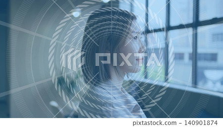 Gazing Asian woman wearing pale blouse, facing right in studio by large window, spiral overlay Gazing Asian woman wearing pale blouse, facing right in studio by large window, spiral overlay 140901874