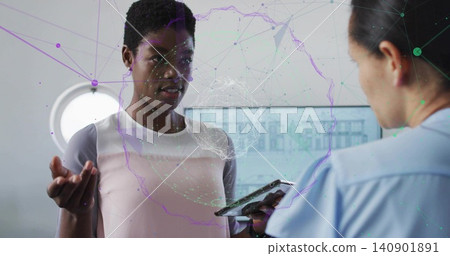 Speaking patient in pale pink top at clinic, nurse in scrubs holding tablet, monitor showing AR Speaking patient in pale pink top at clinic, nurse in scrubs holding tablet, monitor showing AR 140901891
