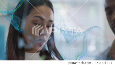 Explaining woman in light turtleneck dark blazer gesturing at clear panel in office, mesh overlay Explaining woman in light turtleneck dark blazer gesturing at clear panel in office, mesh overlay 140901895