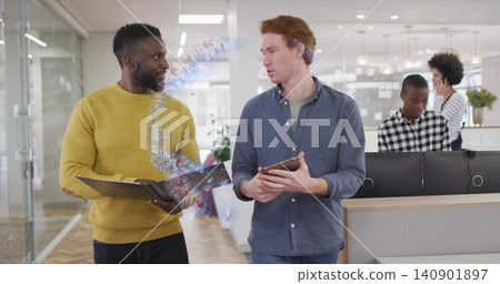 Walking two colleagues in mustard-sweater discussing work in open office, holding tablet, AR ribbon Walking two colleagues in mustard-sweater discussing work in open office, holding tablet, AR ribbon 140901897