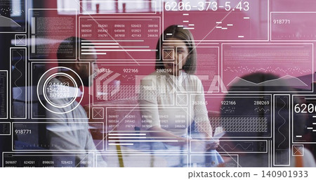 Holding tablet, woman in light blouse leading data meeting in office through glass wall with HUD Holding tablet, woman in light blouse leading data meeting in office through glass wall with HUD 140901933