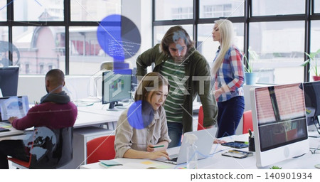Working beige-shirted woman typing on laptop in office while man leaning over reviewing screen Working beige-shirted woman typing on laptop in office while man leaning over reviewing screen 140901934