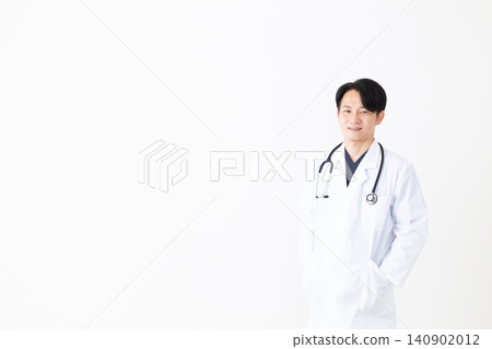 Middle-aged male doctor wearing a white coat Middle-aged male doctor wearing a white coat 140902012