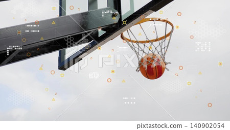 Descending orange basketball passing through net at outdoor court, with rim, overlay, copy space Descending orange basketball passing through net at outdoor court, with rim, overlay, copy space 140902054