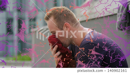 Pressing adult man in navy shirt holding red sweatshirt to nose on urban ledge, pink-purple overlay Pressing adult man in navy shirt holding red sweatshirt to nose on urban ledge, pink-purple overlay 140902161