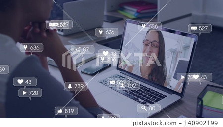 Watching man leaning over laptop at desk, viewing smiling woman with glasses and social overlays Watching man leaning over laptop at desk, viewing smiling woman with glasses and social overlays 140902199