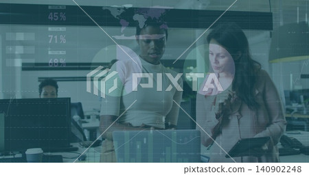 Viewing two women in pink blouse analyzing laptop with tablet and data overlays in open-plan office Viewing two women in pink blouse analyzing laptop with tablet and data overlays in open-plan office 140902248