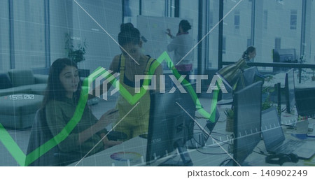 Pointing coworkers in yellow overalls using monitor with green graph overlay in office, copy space Pointing coworkers in yellow overalls using monitor with green graph overlay in office, copy space 140902249