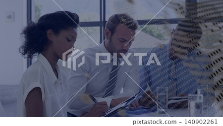 Reviewing three professionals in business attire taking notes in meeting room, with charts and pens Reviewing three professionals in business attire taking notes in meeting room, with charts and pens 140902261