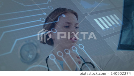 Viewing woman doctor gazing at holographic interface in clinic, wearing white coat and stethoscope Viewing woman doctor gazing at holographic interface in clinic, wearing white coat and stethoscope 140902274
