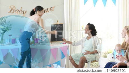 Smiling mother-to-be wearing green maternity dress, touching belly at home with Baby shower banner 140902301