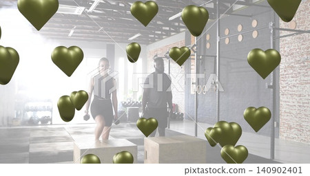 Performing step-up woman in black gym clothes holding dumbbells on plyo box at gym, floating hearts Performing step-up woman in black gym clothes holding dumbbells on plyo box at gym, floating hearts 140902401