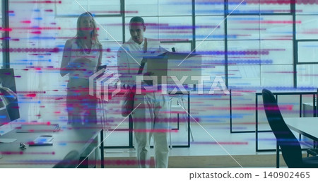 Carrying cardboard box, office man walking through desks, with phone and red garment tied at waist 140902465
