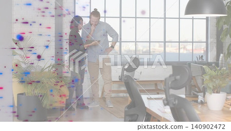 Reviewing tablet, two coworkers in dark blazer and rolled sleeves standing by harbor window, plants Reviewing tablet, two coworkers in dark blazer and rolled sleeves standing by harbor window, plants 140902472