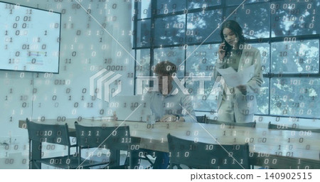 Talking office duo in blazer and shirt holding papers, phone while typing on laptop, binary overlay Talking office duo in blazer and shirt holding papers, phone while typing on laptop, binary overlay 140902515