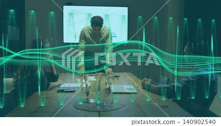 Leaning man in business shirt speaking to team at meeting table, showing display and green waveform Leaning man in business shirt speaking to team at meeting table, showing display and green waveform 140902540