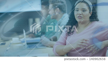 Gesturing woman in pink top patterned band speaking in meeting by glass overlay with laptop papers Gesturing woman in pink top patterned band speaking in meeting by glass overlay with laptop papers 140902638