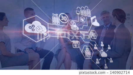 Sitting five professionals in business attire viewing projected hexagonal tech overlay in office Sitting five professionals in business attire viewing projected hexagonal tech overlay in office 140902714