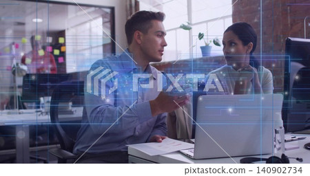 Leaning man in business shirt gesturing while woman listening at open office desk with laptop Leaning man in business shirt gesturing while woman listening at open office desk with laptop 140902734