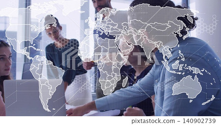 Discussing team pointing at laptop in bright office, wearing business attire with world map overlay Discussing team pointing at laptop in bright office, wearing business attire with world map overlay 140902739
