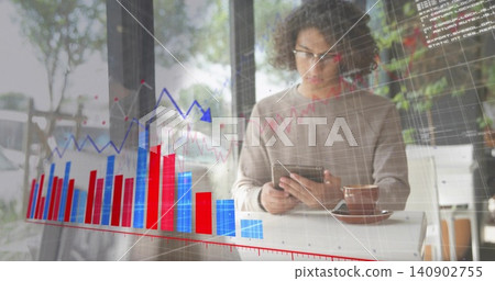 Using tablet, man wearing glasses and sweater viewing charts at cafe window, coffee cup, copy space Using tablet, man wearing glasses and sweater viewing charts at cafe window, coffee cup, copy space 140902755