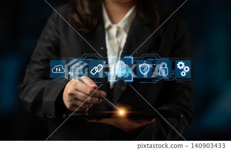 Businessperson Using Digital Tablet for Security Solutions with Various Icons and Graphics on a Dark Background. Entropy 140903433
